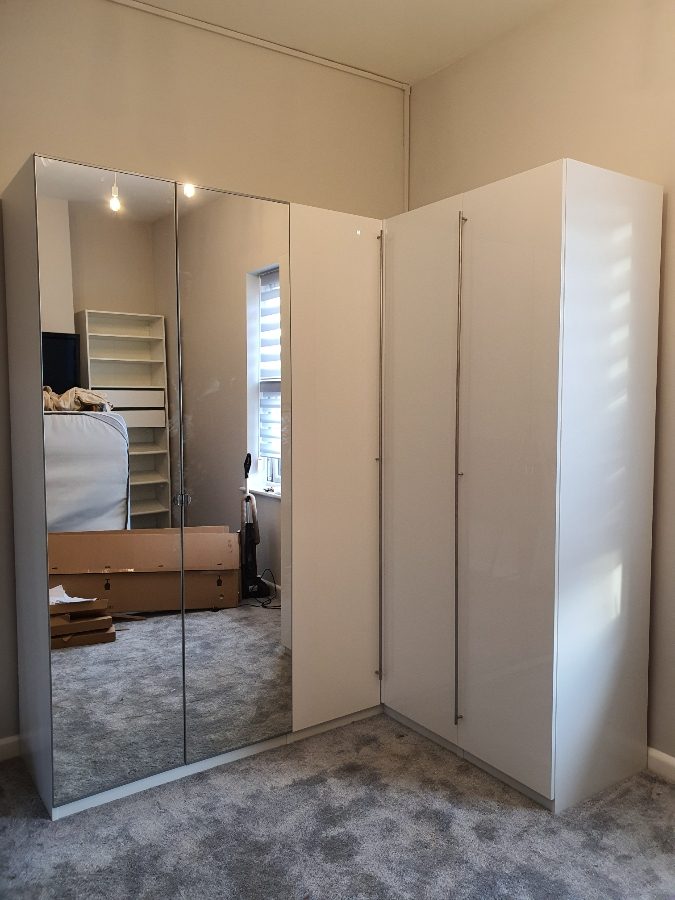 IKEA PAX corner wardrobe with glossy white and mirror doors in Manchester