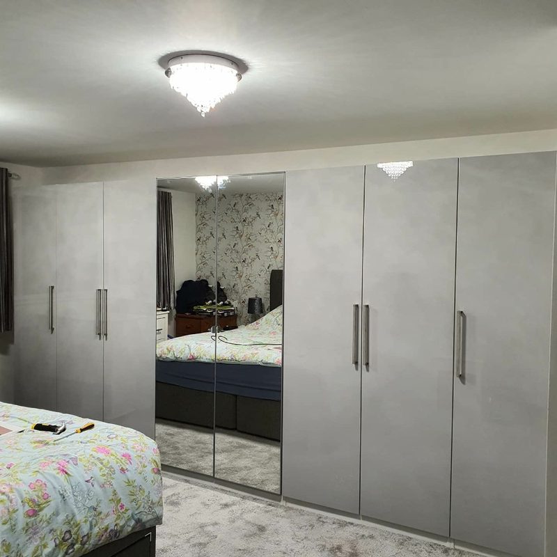 Large IKEA PAX wardrobe with mirror doors in bedroom assembled in Manchester