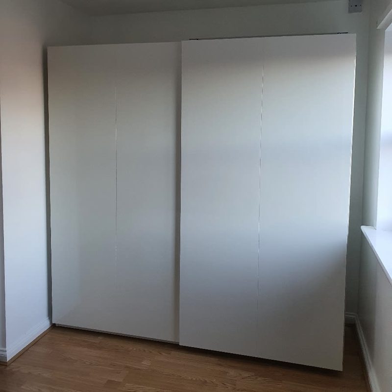 Minimalist white IKEA PAX wardrobe with sliding doors in Greater Manchester